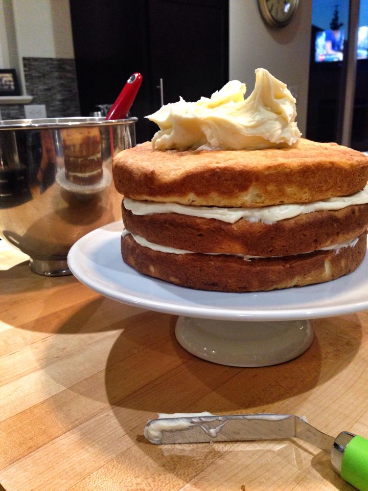 coconut cake being frosted